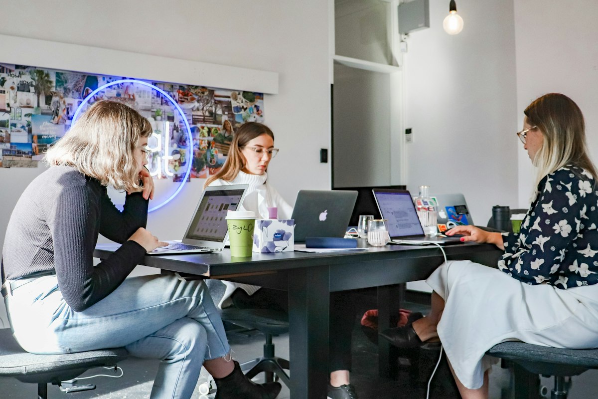 A small marketing team working together around a table